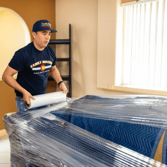 movers wrapping furniture.